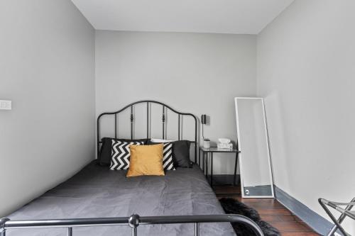 a bedroom with a bed with a metal headboard at 3 bedroom with laundry and parking at Windsor in Windsor