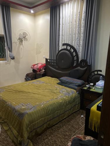 a room with a bed and a chair in it at شقق ايلين 