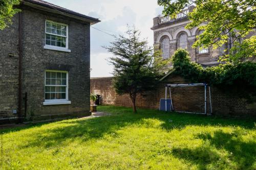 an empty yard in front of a brick building at Hampton Court Cottage in Hampton