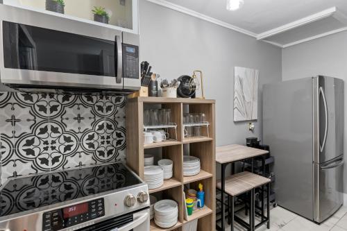 a kitchen with a microwave and a refrigerator at 3 bedroom with laundry and parking at Windsor in Windsor