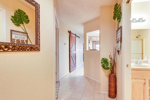 a hallway of a home with a sink and a mirror at Queens Bay Resort Condo Walk to Golf, Pool, Beach in Lake Havasu City