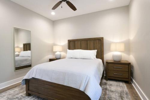 a bedroom with a large bed and a mirror at The Clermont at Clermont Bay in Clermont Harbor