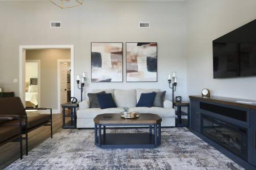 a living room with a white couch and a table at The Clermont at Clermont Bay in Clermont Harbor