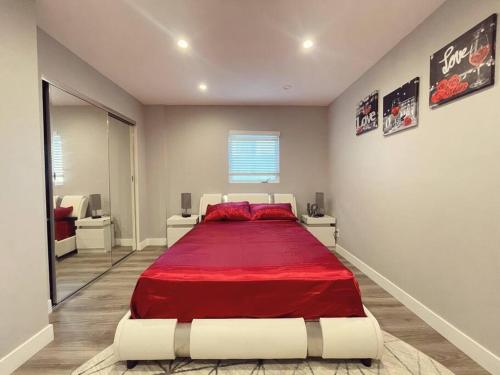 a bedroom with a large bed with a red blanket at 1BD Modern Venice Beach 12A in Los Angeles