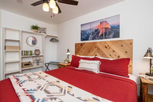 a bedroom with a bed with a red bedspread at Yosemite Summit & Little Summit in Yosemite West