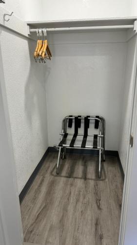a room with a bench with bats on a wall at Hitching Post Studios Inn in Santa Cruz