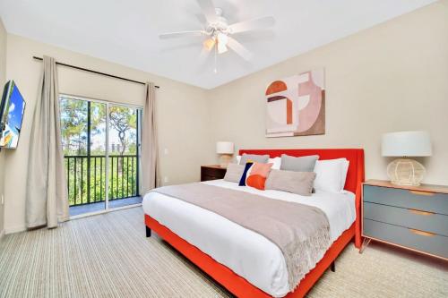 een slaapkamer met een groot bed en een raam bij Modern 2BR Condo - Hot Tub and Pool - Near Disney in Orlando
