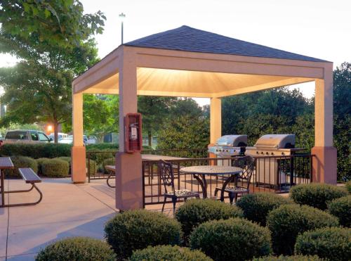a gazebo with a picnic table and two stoves at Sonesta Simply Suites Jacksonville in Jacksonville