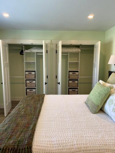 a bedroom with a large bed and some closets at Wellington House in Nanaimo