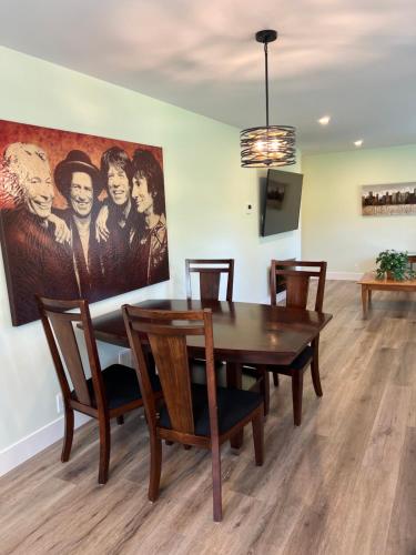 a dining room with a table and a painting on the wall at Wellington House in Nanaimo
