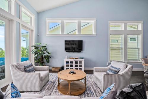 a living room with two chairs and a table at Bay Reserve in Rockport