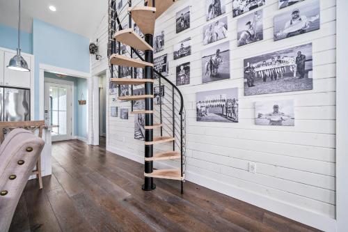 a spiral staircase in a room with white walls at Bay Reserve in Rockport