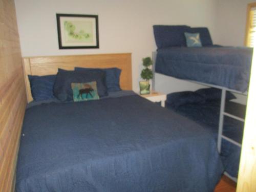 a bedroom with two bunk beds with blue sheets at SEWARD APARTMENT in Seward