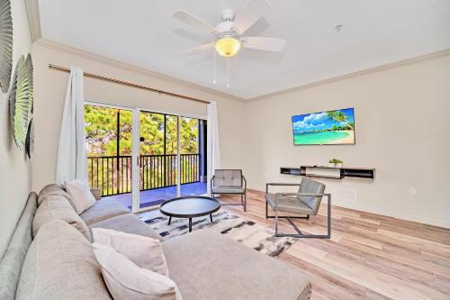 uma sala de estar com um sofá e uma mesa em Spacious 2BR Condo with Pool & Hot tub, near Disney! em Orlando