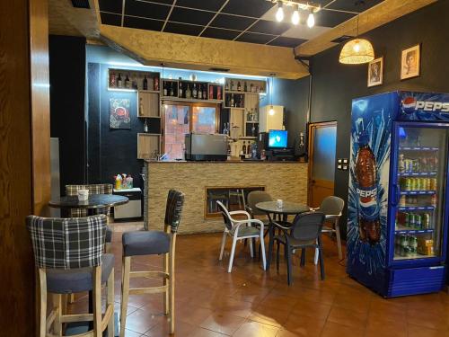 um restaurante com mesas e cadeiras e um bar em Brazil hotel em Peshkopi