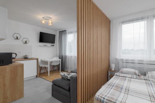 a bedroom with a bed and a chair and a desk at Reymonta 23 B - 5 min Metro - 15 min Centrum - 10 min CMKP in Warsaw