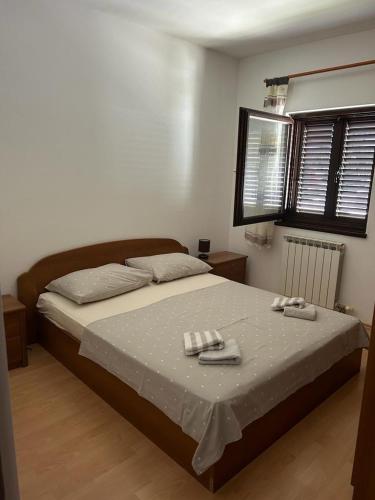 a bedroom with a bed with two towels on it at Apartments by the sea Slatine, Ciovo - 1128 in Slatine