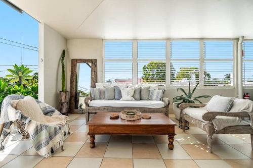 a living room with a couch and a coffee table at Sophie's Place ReLaunch - Luxury Penthouse in Byron Bay