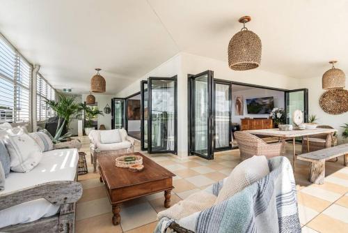 a living room with a couch and a table at Sophie's Place ReLaunch - Luxury Penthouse in Byron Bay