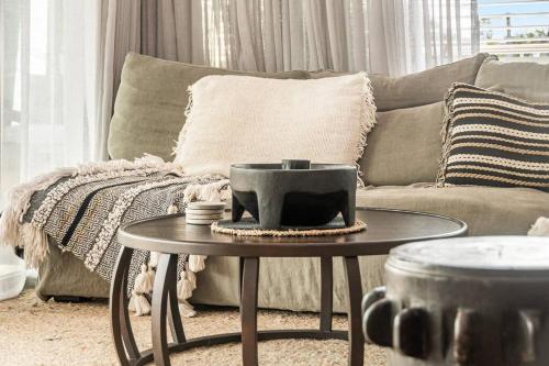 a living room with a couch and a table at Sophie's Place ReLaunch - Luxury Penthouse in Byron Bay