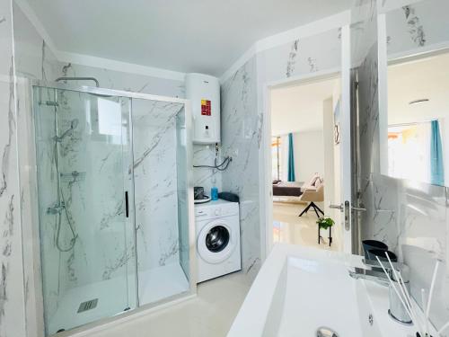 a bathroom with a washing machine and a washer and dryer at Royal View Apartment - Los Cristianos in Los Cristianos