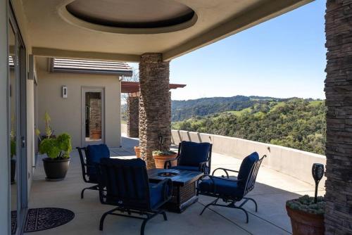 a patio with chairs and a table with a view at Hilltop Vistas-Private Pool, Firepit, Views in Atascadero