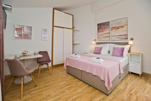 a bedroom with a bed and a desk and a table at Apartments by the sea Hvar - 10430 in Hvar