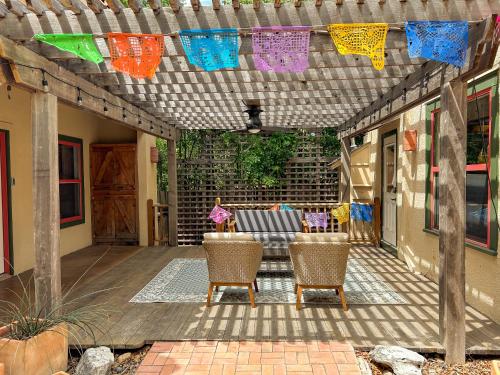 a patio with a couch and chairs under a pergola at Central 1br 1ba SA Casita w full kitchen & patio in San Antonio