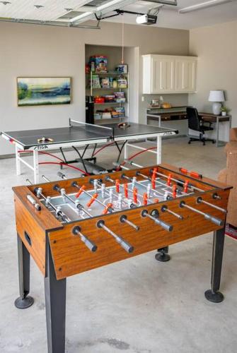 a ping pong table in a room with a chess board at Luxurious, Modern Farmhouse in Wine Country in Atascadero