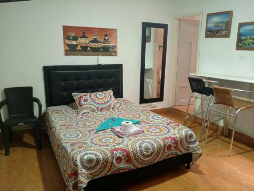 a bedroom with a bed with a table and a mirror at usoinmobiliario in Medellín