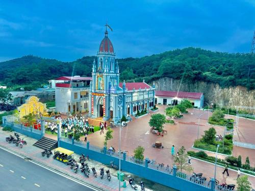a large building with a clock tower in a city at Minh Huy Hotel in Quang Ninh