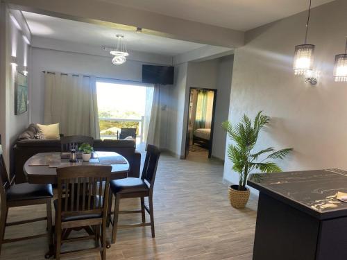 a living room with a table and a dining room at Delta Alpha Apartments in Calliste Land Settlement
