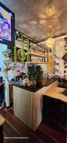 a restaurant with a bar with a tv in a room at Hotel Arte Santa Rosa in Santa Rosa de Cabal