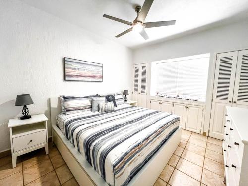 a bedroom with a bed and a ceiling fan at Sandy Beach Princesa D101 Ocean Front Resort in Puerto Peñasco