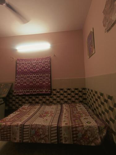 a bedroom with a bed with a blanket on it at Abhay gupta rental in Ghaziabad