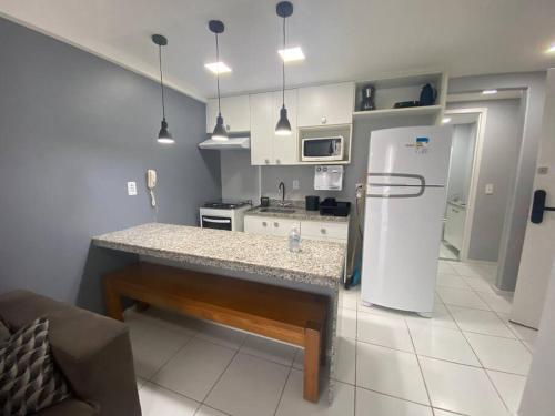 a kitchen with a counter and a refrigerator at Porto Real Resorts - Apartamento com Vista in Mangaratiba