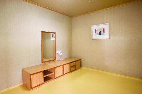 a room with a vanity and a mirror on the wall at Wellihilli Park Resort in Hoengseong