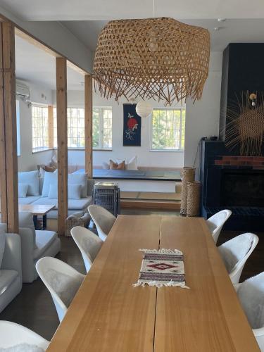 a dining room with a wooden table and chairs at Myoko Forest Lodge in Myoko