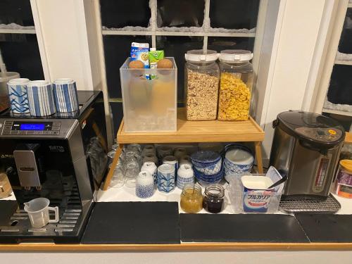 a pantry with jars of food and a microwave at Myoko Forest Lodge in Myoko