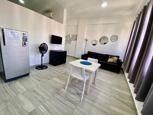 a living room with a white table and a couch at cozy apartment near the beach los corales punta Cana. in Punta Cana
