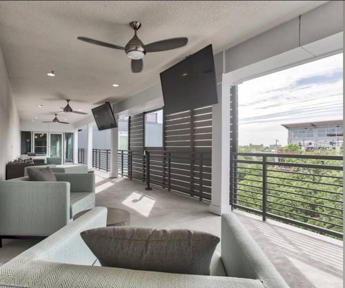 a living room with a view of a balcony at RiverWalk PentHouse Oasis w/Free Parking Gym Pool in San Antonio
