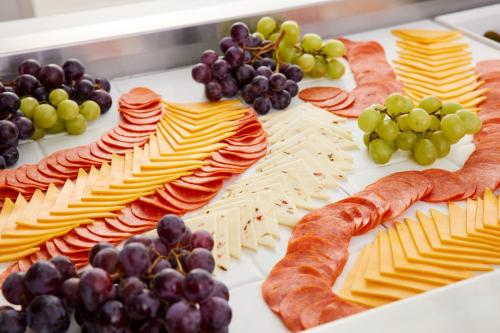 a tray of cheese and grapes and meats and cheese gmaxwell gmaxwellzos at Staybridge Suites Tucson Airport by IHG in Tucson