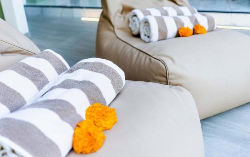 two brown and white couches with teddy bears on them at Eden Garden Villa Canggu in Canggu