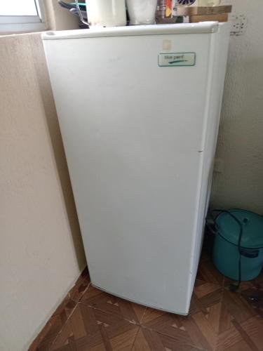 a white refrigerator in a corner of a kitchen at Estudio 