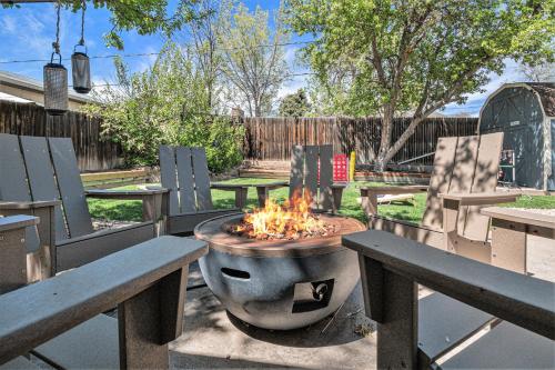 a fire pit sitting in the middle of two benches at Heights Hideaway - Great Location - Game and Movie Room in Westminster