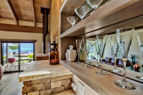 a kitchen with several wine glasses on a counter at Lakeland Village 620 - Beachfront Bliss in South Lake Tahoe