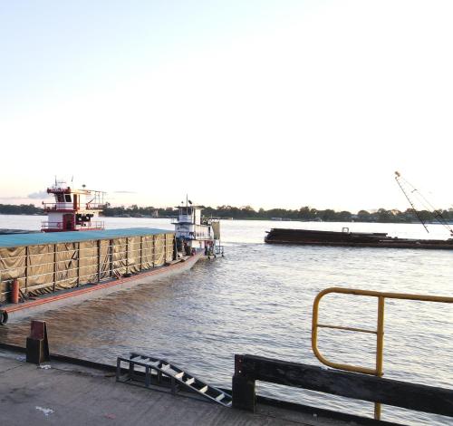 a barge is docked at a dock in the water at Cruz Roja - Turismo Solimões in Leticia