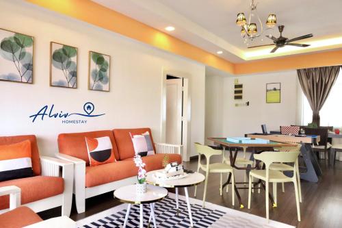 a living room with a couch and tables and chairs at Costa Mahkota - 1min I Mahkota Parade Mall I Dataran Pahlawan I Mahkota Hospital in Melaka