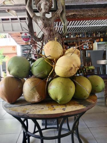 a pile of coconuts on top of a table at Ganesh Lodge in Candidasa