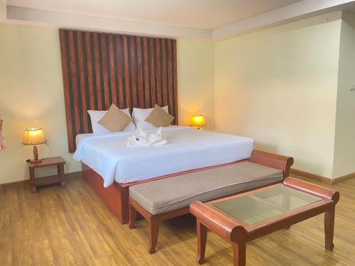 a hotel room with a bed and a table at Phi Phi Little Star Resort in Phi Phi Islands